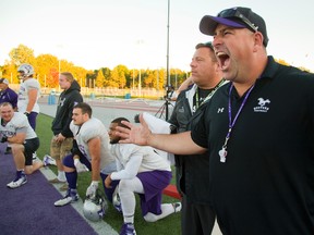 Mustangs coaches Paul Sguigna (RB?s), left, and Chris Bertoia (O-line) are serious guys, at least until Bertoia sees a camera during a Western practice before facing Waterloo this weekend, or when they closed out Western?s J.W. Little Stadium years ago while playing for the Warriors. Mike Hensen/The London Free Press