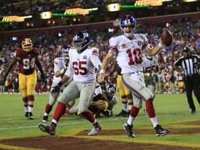 Quarterback Eli Manning of the New York Giants celebrates his 4th quarter touchdown against the Washington Redskins at FedExField on September 25, 2014. (Rob Carr/Getty Images/AFP)