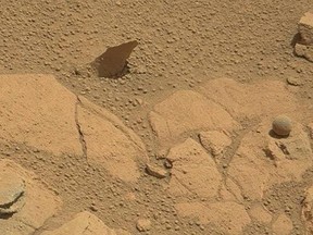NASA's Curiosity Rover has photographed this sphere that looks oddly like a ball on Sept. 11, 2014. Experts say they believe the ball is an example of a geological process called concretion. (NASA/Handout/QMI Agency)