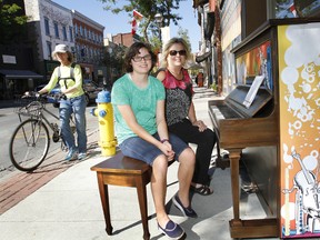 Janet Harnden, owner of Pinnacle Music Studios, and music student Emma Gorman showcase this old Heintzman piano displayed outside the Front Street store in downtown Belleville, Ont. Friday afternoon, Sept. 26, 2014 as The Friendly City tunes in to its second annual Culture Days this weekend. Following last year's success, the city's Culture Days planning committee created a wider, louder and more colourful menu for this year's festivities. Check out www.bellevilleculturedays.com for a full list of events with schedule information. - JEROME LESSARD/THE INTELLIGENCER/QMI AGENCY