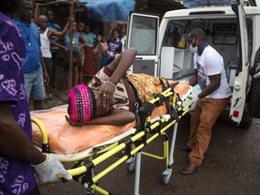 A pregnant woman suspected of contracting Ebola is lifted by stretcher into an ambulance in Freetown, Sierra Leone September 19, 2014 in a handout photo provided by UNICEF. (REUTERS/Bindra/UNICEF/handout via Reuters)