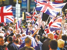 Pro-union protestors chant and wave Union Flags during a demonstration at George Square in Glasgow, Scotland, after Scotland spurned independence in a historic referendum. The result has ushered in a period of intense bargaining over Britain?s Prime Minister David Cameron?s pre-vote pledges to give Scots more say over their own affairs. (Cathal McNaughton/ REUTER)