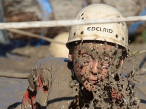 A cadet emerges from a water-filled ditch during the annual First Year Orientation Program (FYOP) obstacle course at the Royal Military College of Canada Friday, Sept. 26, 2014 in Kingston, Ontario. 
ELLIOT FERGUSON/KINGSTON WHIG-STANDARD/QMI AGENCY