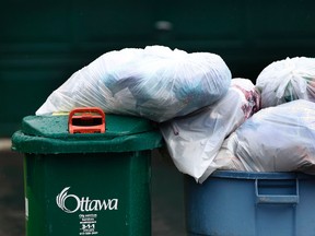 Garbage pickup in Barrhaven, On. Tuesday June 25, 2013.  Tony Caldwell/Ottawa Sun/QMI Agency