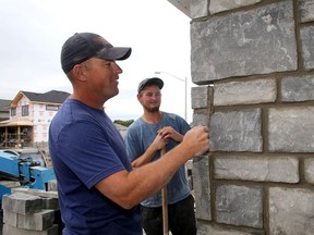 Stone and brick Mason Frank Ottenhof, left, with his labourer Jacob Wray-Baker work on a new home in Amherstview on Tuesday September 23 2014. (IAN MACALPINE)-KINGSTON WHIG-STANDARD/QMI AGENCY