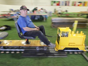 Maurice Dorge, the man behind the Manitoba Mega Rrain show, rides a small train at the Canlan Sportsplex, in Winnipeg.