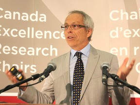 Dr. Gilles Gerbier accepts the applause of his audience on the Queen's University campus Friday morning following the announcement of a $10,000,000 research award for Gerbier, who just arrived at Queen's from France.  FRI., SEPT. 26, 2014 KINGSTON, ONT. MICHAEL LEA THE WHIG STANDARD QMI AGENCY