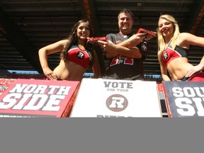 George Hanna of Gabriel's Pizza shares a slice of Southside and a slice of Northside pizza with RedBlacks cheerleaders Brittany, left, and Claudia on Friday, Sept. 26, 2014.
DOUG HEMPSTEAD/Ottawa Sun/QMI AGENCY