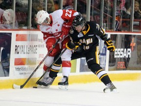 Soo Greyhound Charley Graaskamp and Pavel Zacha of the Sarnia Sting battle for the puck in Sault Ste. Marie Sept. 26, 2014 during the Greyhound's home opener. (STEPH CROSIER/ THE SAULT STAR)