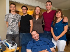 Bruce Ayton, seated, who suffers from ALS, will be at the ALS walk Saturday with family members who will walk for and with their husband and father. From left, James, Justin, Kirsten and Nathan Ayton and Bruce?s wife, Barbara Ayton. (MIKE HENSEN, The London Free Press)