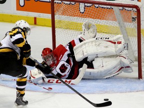 Kingston Frontenacs Ryan Kujawinski tries to get a shot off on Ottawa 67's goalie Leo Lazarev during Ontario Hockey League action at the Rogers K-Rock Centre in Kingston on Friday September 26 2014. (IANMACALPINE)-KINGSTON WHIG-STANDARD/QMI AGENCY
