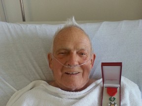 Decorated war vet William Sam Magee in hospital with his medal after being knighted by France earlier this year. (Photo courtesy the Magee family)