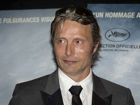 Danish actor Mads Mikkelsen poses prior to the film screening of "The Salvation" in Paris on August 26, 2014. AFP PHOTO / FRED DUFOUR