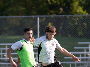 Ottawa Fury FC's Mauro Eustaquio, left, and Tommy Heinemann, battle for the ball during training Saturday at Algonquin College. (Chris Hofley/Ottawa Sun)
