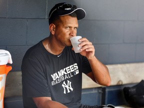 New York Yankees' Alex Rodriguez takes a drink in the dugout during a rehab assignment with the Tampa Yankees in Tampa, Florida in this file photo taken July 13, 2013. (REUTERS/Mike Carlson/Files)