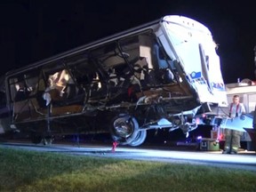 The North Central Texas College bus that was involved in a crash is being removed near Ardmore, Okla., on September 26, 2014 in this still image captured from KXAS TV video footage. Four female college softball players were killed and a dozen others were injured when their bus was involved in a crash on an Oklahoma highway late on Friday. (REUTERS/Courtesy KXAS/Handout)