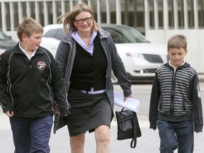 City councillor Paula Havixbeck arrives at City Hall with her sons Nick (l) and Adrian to file her nomination papers for mayor May 14, 2014.