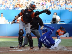 Kevin Pillar of the Toronto Blue Jays slides home past Baltimore Orioles catcher Caleb Joseph to score in the third inning at Rogers Centre on Sept. 27, 2014. (PETER LLEWELLYN/USA TODAY Sports)