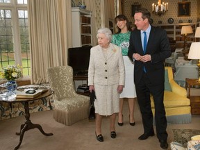 Britain's Prime Minister David Cameron and his wife Samantha escort Queen Elizabeth and Prince Philip (obscured) as they tour Chequers, the Prime Minister's official country residence, near Ellesborough in southern England February 28, 2014. REUTERS/Stefan Rousseau/pool