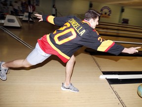 Defenceman Cole Candella scores a strike for lung health during the 11th Annual Bowling with the Bulls in support of the Ontario Lung Association at Quinte Bow in Belleville, Ont. Sunday, Sept. 28, 2014. - JEROME LESSARD/THE INTELLIGENCER/QMI AGENCY