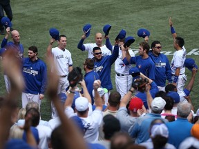 Toronto Blue Jays players salute the fans in the fourth inning during MLB game action against the Baltimore Orioles on September 28, 2014 at Rogers Centre in Toronto, Ontario, Canada. (Tom Szczerbowski/Getty Images/AFP)