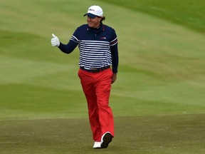 U.S. Ryder Cup player Phil Mickelson gestures to fans as he walks up the second fairway during the 40th Ryder Cup singles matches at Gleneagles in Scotland September 28, 2014. (REUTERS)