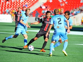 Fury midfielder Sinisa Ubiparipovic does he can to get the ball past Minnesota United players during Sunday's match in Ottawa at TD Place. DEAN JONCAS/OTTAWA SUN