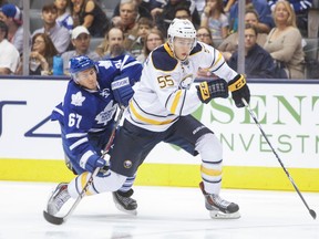 Maple Leafs winger Brandon Kozun loses his footing as he chases Buffalo Sabres defenceman Rasmus Ristolainen during pre-season action at the Air Canada Centre last night. (Ernest Doroszuk/Toronto Sun)