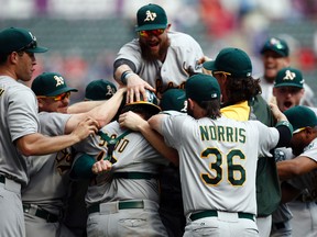 Athletics storm the field after clinching a wild-card berth.  (USA TODAY)