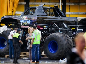 Dutch policemen inspect the site of an accident after a "monster truck" drove accidentally into the audience during a demonstration in Haaksbergen, killing three people and injuring dozens, on Sept. 28, 2014. (AFP PHOTO/ANP/VINCENT JANNINK)