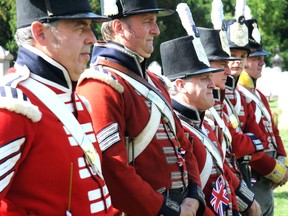 Soldiers stand at attention as the  Upper Canada Military Re-enactment Society perform a ceremony at Brick Street Cemetery commemorating those who fought in 1812. GERARD CRECES\SPECIAL TO LONDONER