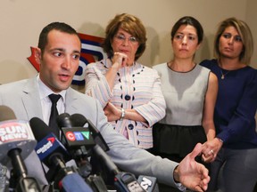 Cy Tokmakjian's son Raffi -- flanked by Cy's wife Helen and daughters Sylvia and Ani -- speaks at a press conference Monday, Sept. 29, 2014. (DAVE THOMAS/Toronto Sun)