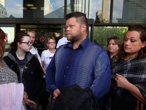 Trevor Hurlbert (c) speaks to the media about his son Travis, who was killed in a motor vehicle accident. The Hurlbert family was at the downtown courthouse to issue their victim impact statement in Edmonton, Alberta on September 29, 2014. Perry Mah/Edmonton Sun
