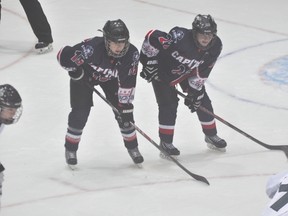 Key Central Plains Capitals Female AAA MIdget returning players Emily Upgang, left, and Tamara McVannel, right, line up for a faceoff Sunday.