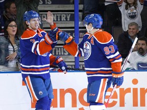 Jeff Petry, shown here celebrating a goal with teammate Ryan Nugent-Hopkins late last season, suffered a shoulder injury on the first day of camp that had him listed as day to day. (Ian Kucerak, Edmonton Sun)