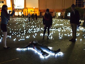 Revellers check out Glow in the Park(ing Lot) from Nuit Blanche Winnipeg 2013. This year's version of the all-night art party goes Sat., Sept. 27.  Handout//Winnipeg Sun