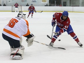Kingston Voyageurs' Matt Hoover gets poke-checked by Orangeville Flyers goalie Nicholas Latinovich during the Voyageurs' Ontario Junior Hockey League season opener at the Invista Centre on Sept. 12. The Voyageurs (6-1) are ranked No. 16 in the Canadian Junior Hockey League. (IAN MACALPINE/THE  WHIG-STANDARD)