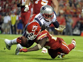 Kansas City Chiefs running back Jamaal Charles fumbles the ball into the end zone while being tackled by New England Patriots outside linebacker Jamie Collins at Arrowhead Stadium in Kansas City, Sept. 29, 2014. (JOHN RIEGER/USA Today)