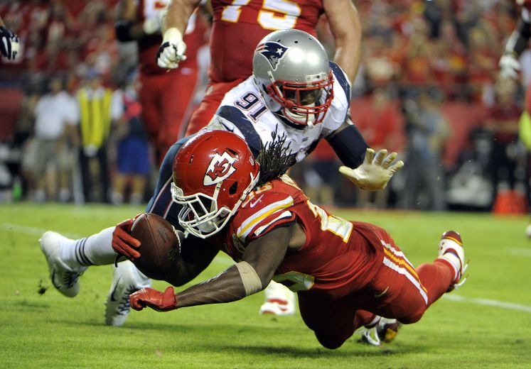 Kansas City Chiefs free safety Husain Abdullah carries the ball after  intercepting a pass and running it back 39 yards for a touchdown during the  fourth quarter of an NFL football game