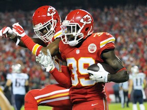 Kansas City Chiefs free safety Husain Abdullah (right) is congratulated by cornerback Sean Smith after returning an interception for a touchdown against the New England Patriots at Arrowhead Stadium, Sept. 29, 2014. (DENNY MEDLEY/USA Today)