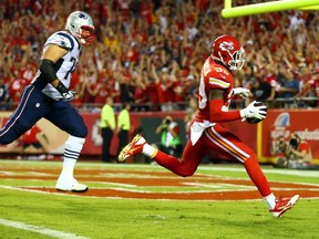 Husain Abdullah #39 of the Kansas City Chiefs scores a touchdown after an interception against the New England Patriots at Arrowhead Stadium on September 29, 2014 in Kansas City, Missouri. (Dilip Vishwanat/Getty Images/AFP)
