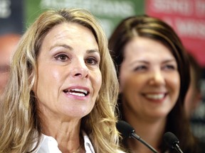 Former Calgary police officer Kathy Macdonald and Wildrose Leader Danielle Smith speak to media on Tuesday, Sept. 30, 2014. Macdonald will run against Premier Jim Prentice in the upcoming round of byelections on Oct. 27. (LYLE ASPINALL/CALGARY SUN)