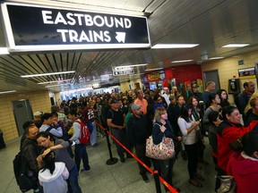 TTC subway riders scramble to get on a shuttle bus at Keele Station after a subway shutdown in Toronto on Tuesday September 30, 2014. (Dave Abel/Toronto Sun)