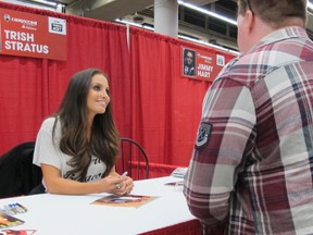 Trish Stratus smiles as a fan approaches her table at a recent autograph-signing event. (Stratus Enterprises, Inc.)