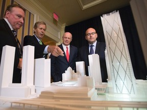 From left, Paul Gleeson, executive vice-president, Global Development with Ivanhoe Cambridge; Metrolinx Chair Robert Prichard; Daniel Fournier, chairman and CEO of Ivanhoe Cambridge; and Transportation Minister Steven Del Duca show off the model of a new office tower and GO Bus terminal project at Front and Bay Sts. in Toronto on Tuesday, September 30, 2014. (Dave Abel/Toronto Sun)
