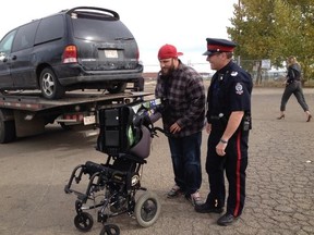 Phillip Hulmes with his daughter's wheelchair on Sept. 30, 2014. Police recovered it from a stolen van. (PERRY MAH/EDMONTON SUN)