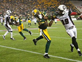 Paris Jackson, right, tries to hold off Eskimos DB Joe Burnett during a game at Commonwealth Stadium in July. (Codie McLachlan, Edmonton Sun)