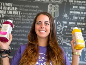 Lanie Avola shows off bottles of juice at Pulp & Press Juice Co. on Central Ave. (CRAIG GLOVER/The London Free Press)