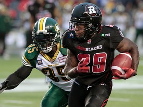 Eskimos linebacker Rennie Curran tracks down Ottawa running back Chevon Walker earlier this season (Tony Caldwell, QMI Agency).