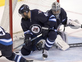 Winnipeg Jets defenceman Zach Bogosian (l) and goalie Ondrej Pavelec stop an Ottawa Senators shot during NHL hockey in Winnipeg, Man. Tuesday, September 30, 2014.
Brian Donogh/Winnipeg Sun/QMI Agency